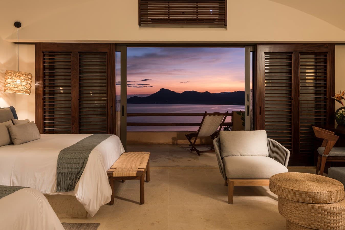 Wake up to breathtaking ocean and mountain views from your comfortable bed, where the horizon becomes part of your room through expansive glass doors opening to your private terrace.