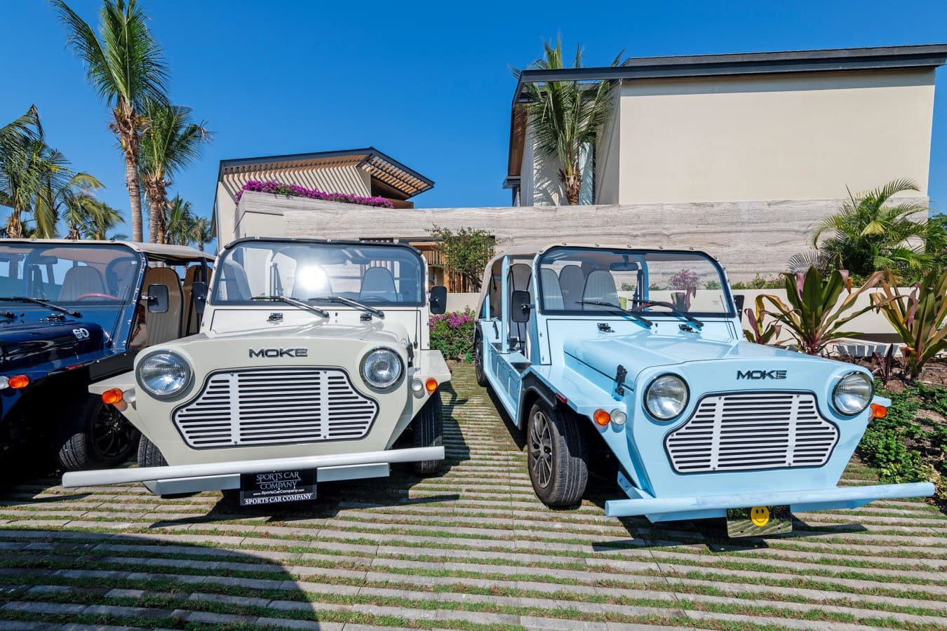 Modern beach property with complimentary resort vehicles for your convenience. Enjoy easy transportation around the area in style, with tropical landscaping and clear blue skies setting the scene for your getaway.