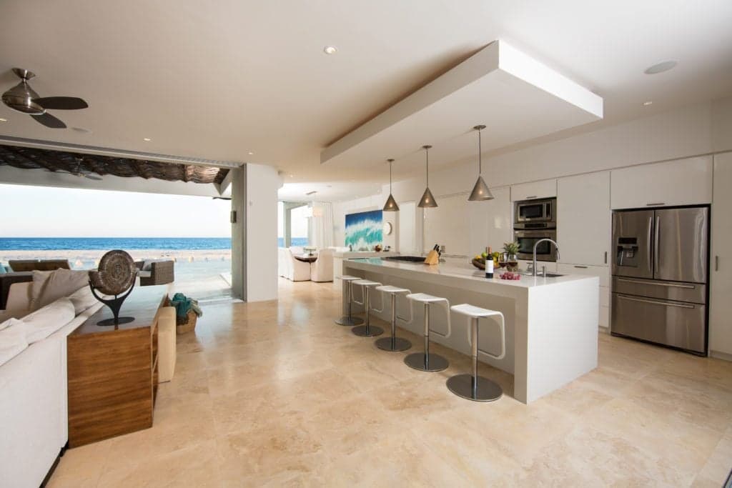 A view of the kitchen and its bar seating.