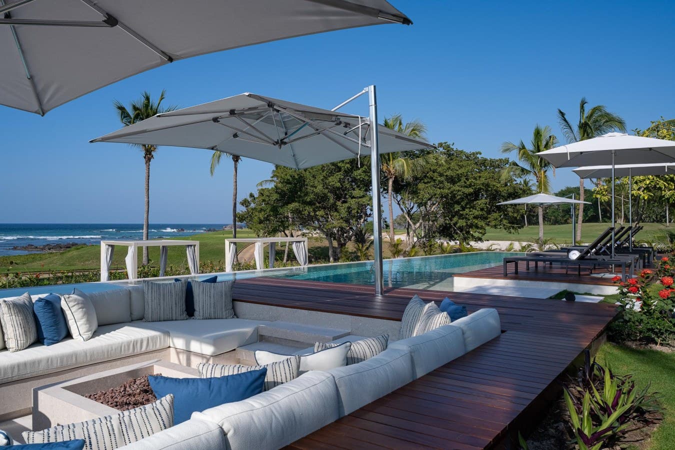 Sink into plush outdoor loungers by your private pool, where the ocean stretches endlessly before you and swaying palms frame every moment of pure tropical bliss.