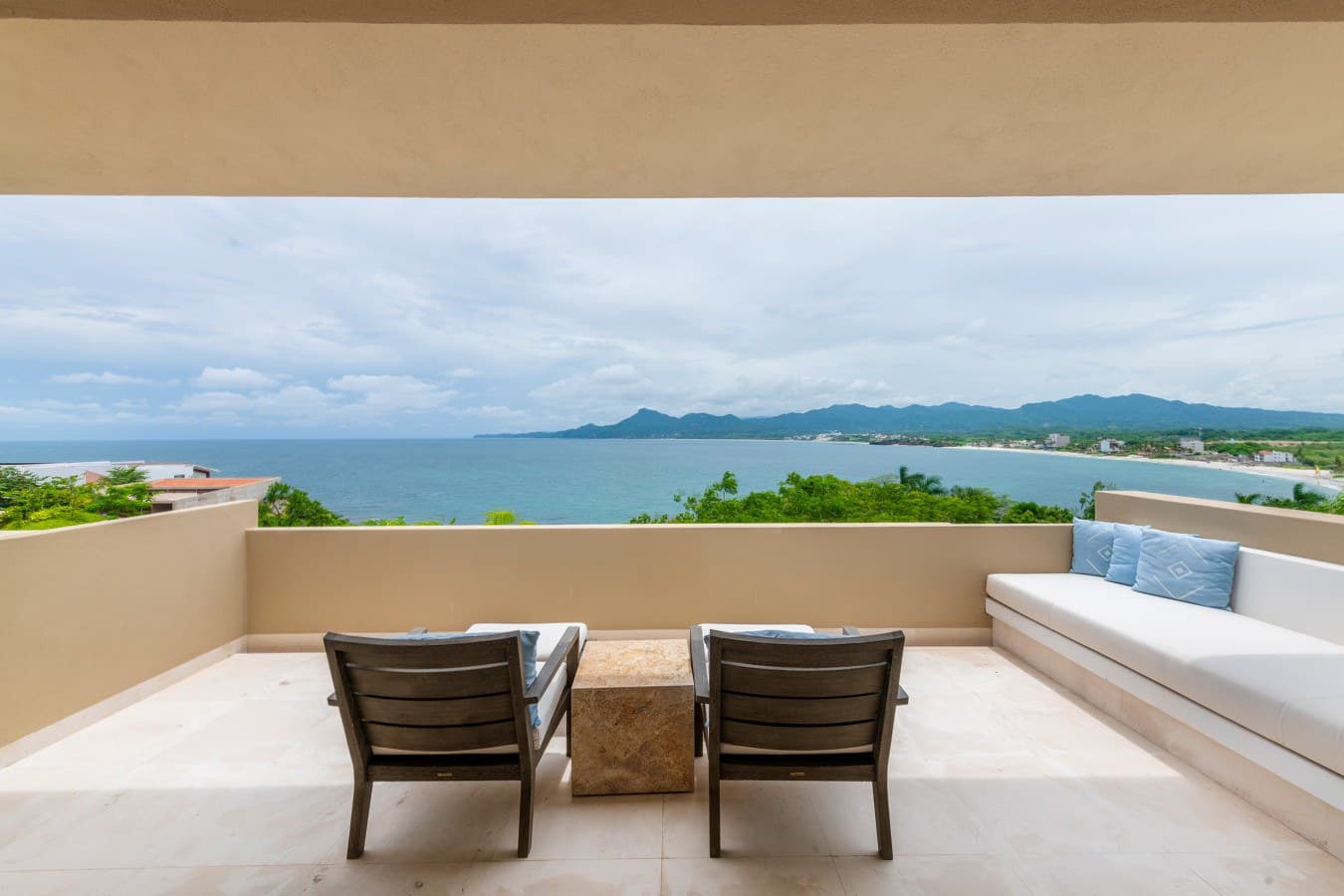 Relax on your private terrace with stunning ocean and mountain views. Sink into lounge chairs or the built-in daybed as gentle coastal breezes sweep across the peaceful setting.