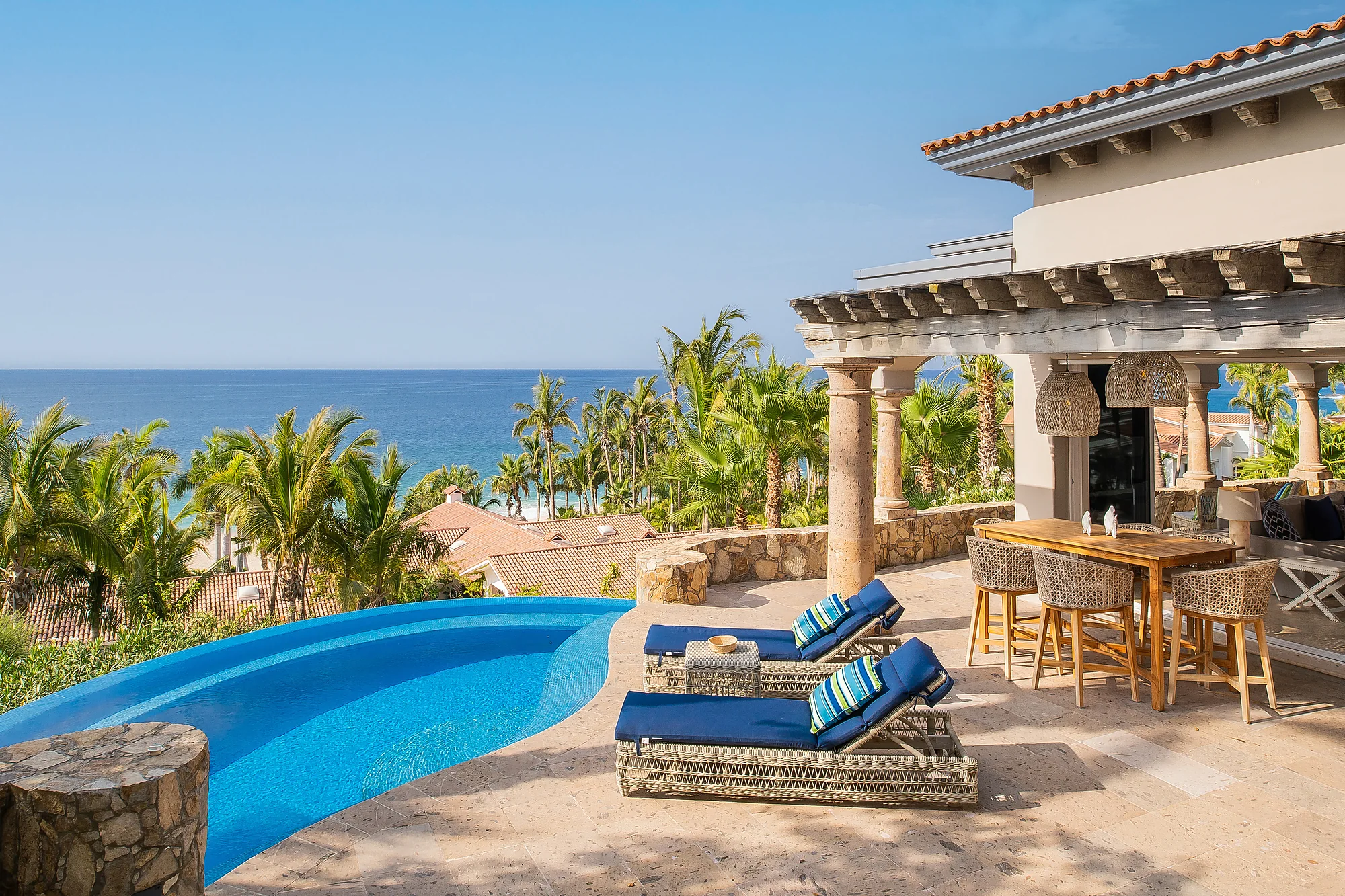 The pool and patio space of Casita 6, with blue chairs by the side.