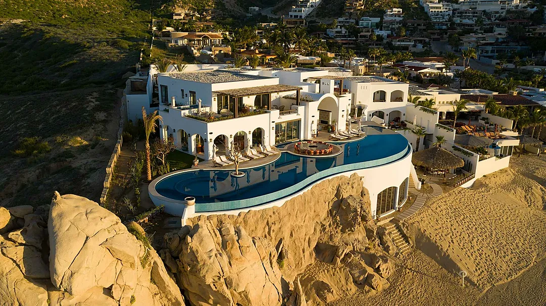 An aerial view of the pool of this Los Cabos beachfront villa, as seen at sunset.
