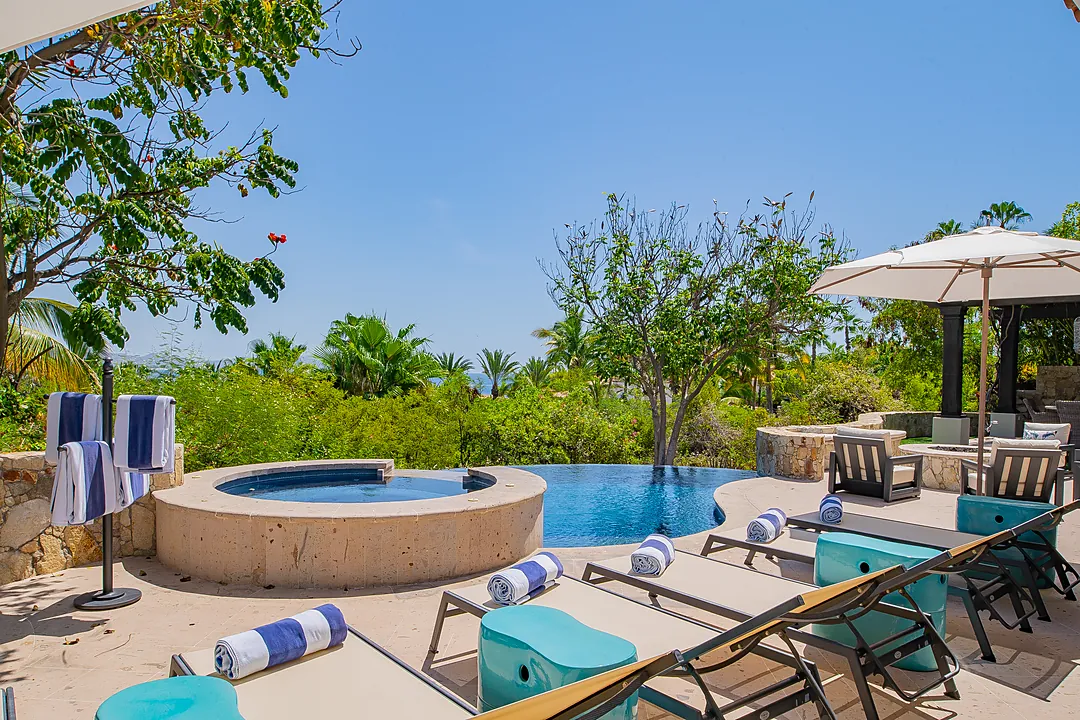 Unwind poolside in your private oasis, where turquoise loungers, a sparkling infinity pool, and a hot tub meet lush tropical gardens and ocean views beyond.