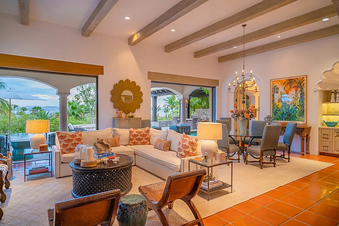 Relax in your spacious living room with exposed beams, curated artwork, and seamless indoor-outdoor flow to the pool and tropical gardens beyond.