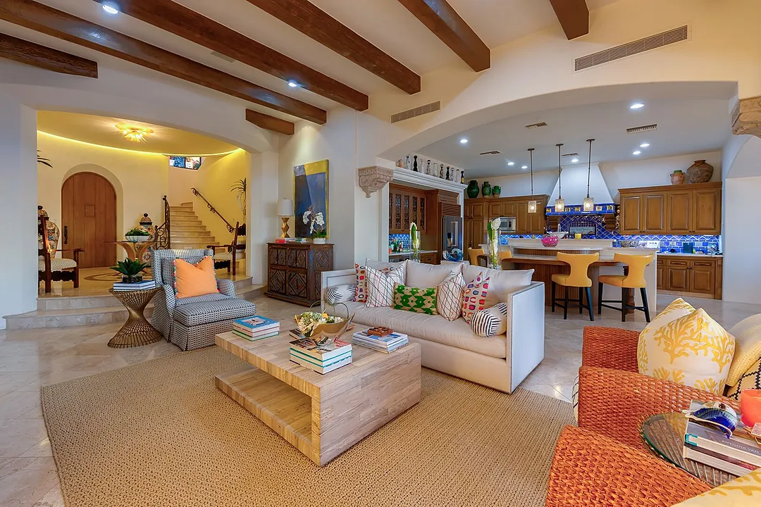 Another seating area next to the kitchen with multiple chairs and a custom coffee table.