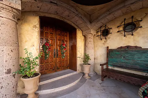 The main front wooden double doors of the villa.