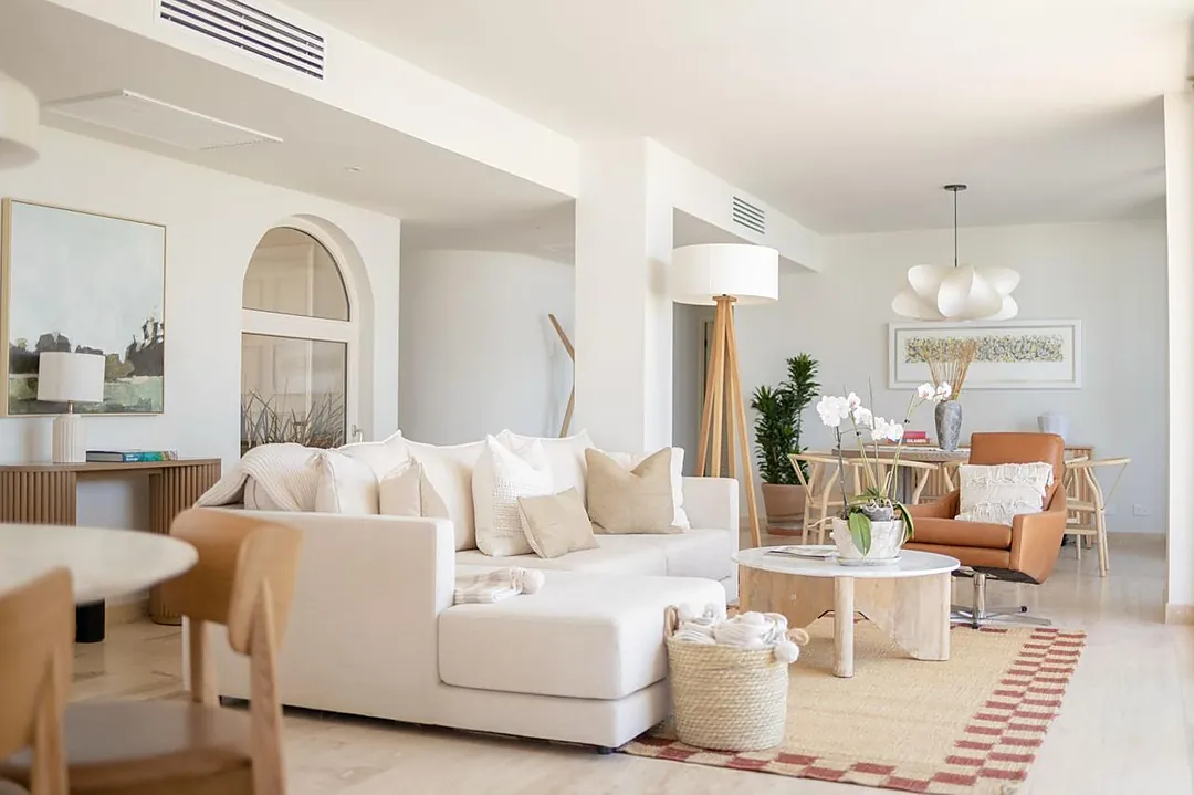 Sink into plush sofas and unwind in this bright, open living space where warm textures and natural light create a serene atmosphere perfect for your getaway.