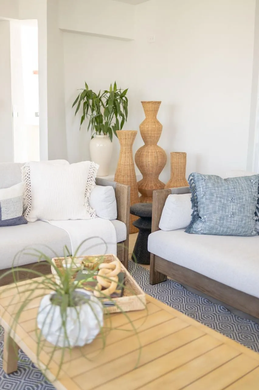 Unwind in your serene living space, where coastal textures, plush seating, and natural greenery create the perfect retreat for relaxation and rejuvenation.