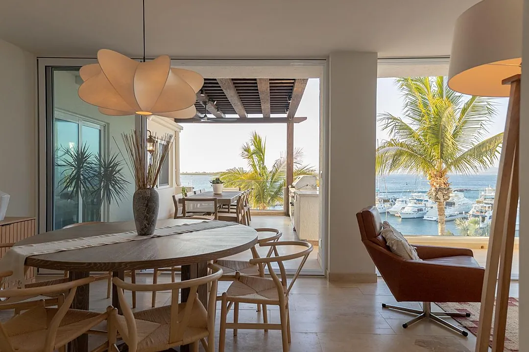 Enjoy your morning coffee at the dining table while soaking in stunning marina and ocean views through floor-to-ceiling windows. The seamless indoor-outdoor flow leads to your private terrace, perfect for sunset gatherings.