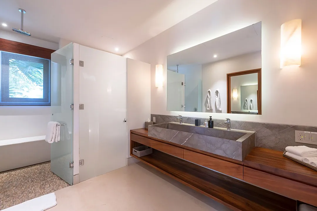 Bathroom 1 (Master ensuite) · Your private spa-like bathroom features a sleek floating vanity, luxurious soaking tub, and rainfall shower—where modern elegance meets total relaxation.