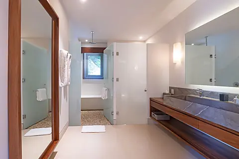 Bathroom 1 (Master ensuite) · Step into your private spa-like retreat with warm wood accents, dual vanities, and a luxurious walk-in shower surrounded by natural light.
