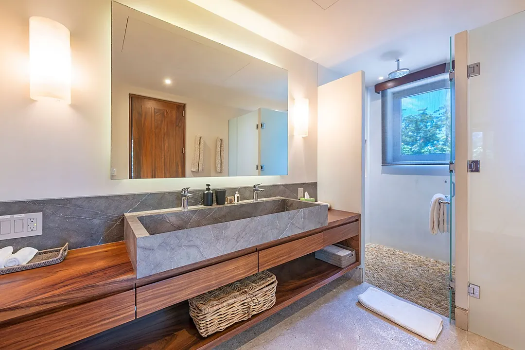 Bathroom 3 · Step into your private spa-like retreat, where warm wood and cool stone blend beautifully. The unique double vanity and rainfall shower invite you to unwind in pure comfort.