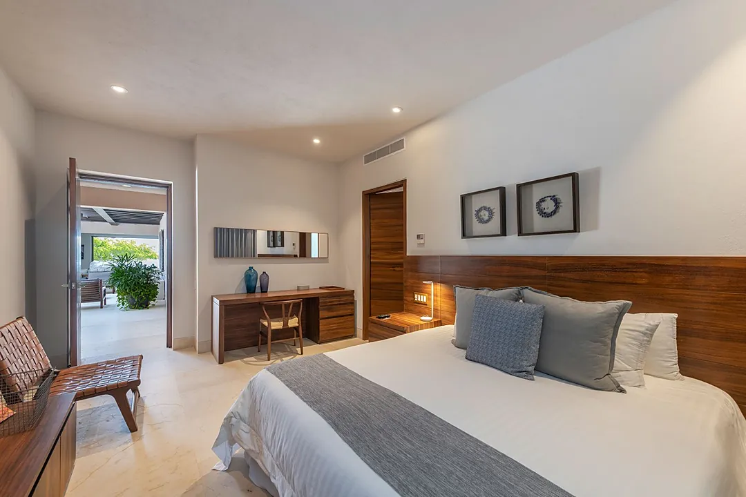 Bedroom 4 · Step into your peaceful retreat with warm wood tones and crisp linens inviting you to unwind. Natural light flows through to a private outdoor space, while thoughtful touches create the perfect blend of modern comfort and relaxed elegance.