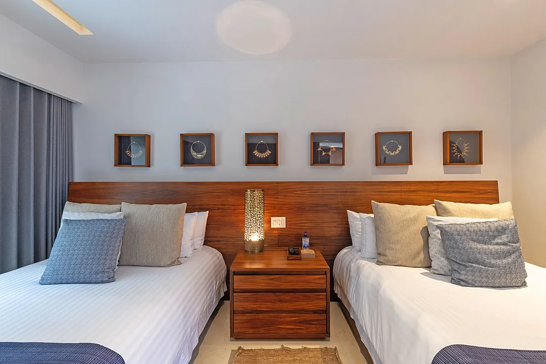 Bedroom 3 · Settle into your cozy twin bedroom featuring rich wood tones and soft linens. The crisp white bedding and layered pillows invite you to unwind after a day of exploring.