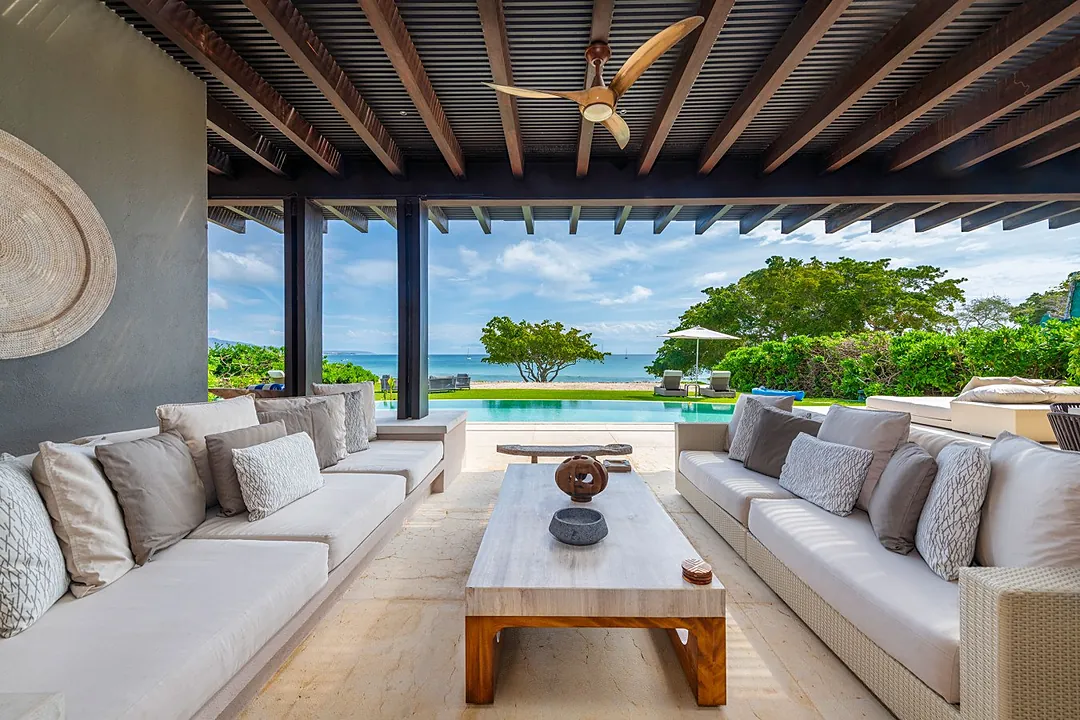Settle into your covered lounge, where ocean breezes drift through wide-open walls, and the turquoise pool meets endless sea views. Your perfect sanctuary awaits.