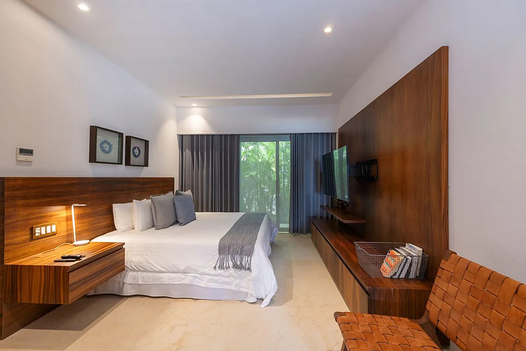 Bedroom 4 · Step into your serene retreat with warm wood accents, crisp linens, and a peaceful garden view framing your private escape.