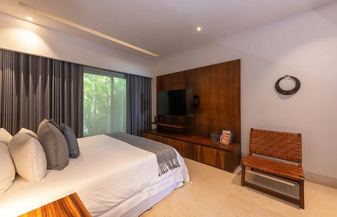 Bedroom 4 · Slip into crisp white linens and unwind in your serene bedroom, where natural light filters through garden views and modern wood accents create a warm, contemporary retreat just for you.