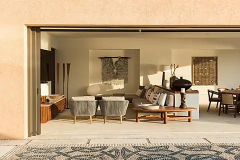 Step through the open terrace doors into your serene living space, where natural textures and artistic touches create a warm, inviting atmosphere. Sink into stylish seating as soft light fills the room, making every moment feel effortlessly peaceful.