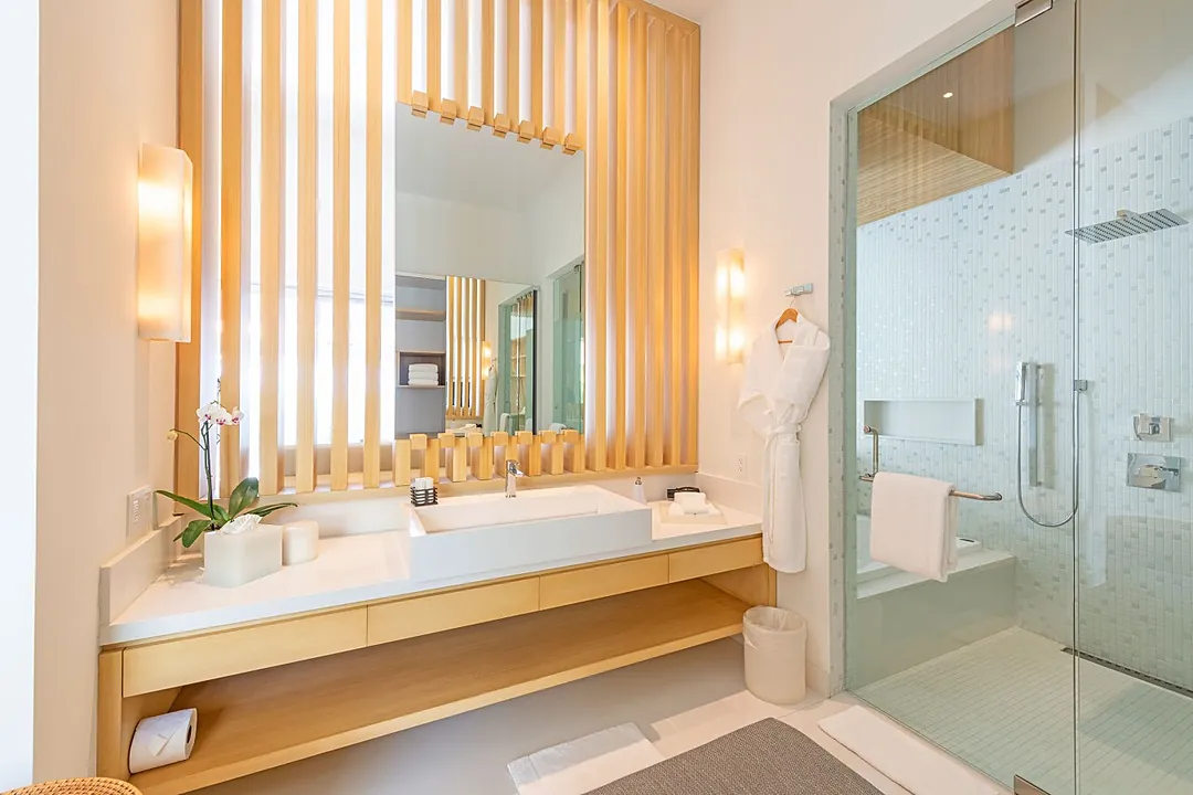 Bathroom 2 · Step into your private spa-like sanctuary, where warm wood tones and soft lighting create a tranquil escape. A spacious walk-in shower and soothing natural materials invite you to truly unwind.