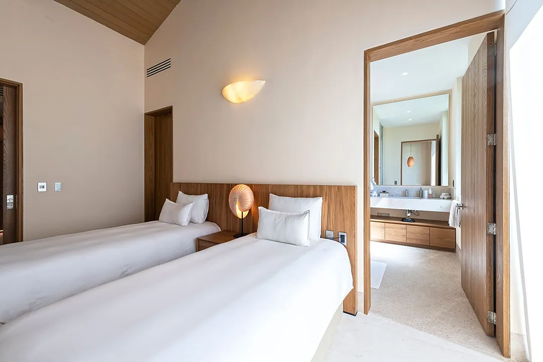 Bathroom 5 · Step inside your spa-inspired bathroom where fresh towels await on open wooden shelves, the sliding barn door adds modern charm, and soft ambient lighting creates the perfect setting for your daily refresh.