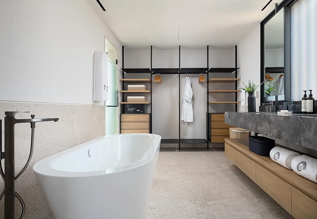 Bathroom 1 (Master ensuite) · Slip into your own spa-like retreat with a luxurious soaking tub and modern fixtures. Open shelving keeps your essentials close at hand, while soft robes and fresh towels await.