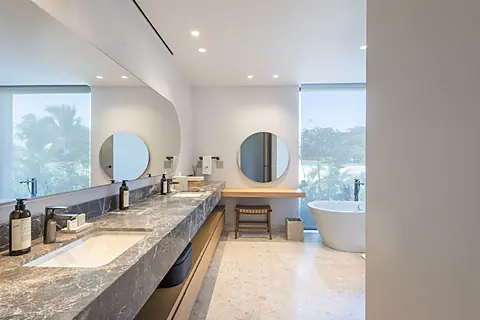 Bathroom 1 (Master ensuite) · Sink into luxury in your spa-inspired bathroom with dual vanities, soaking tub, and peaceful views of tropical greenery.