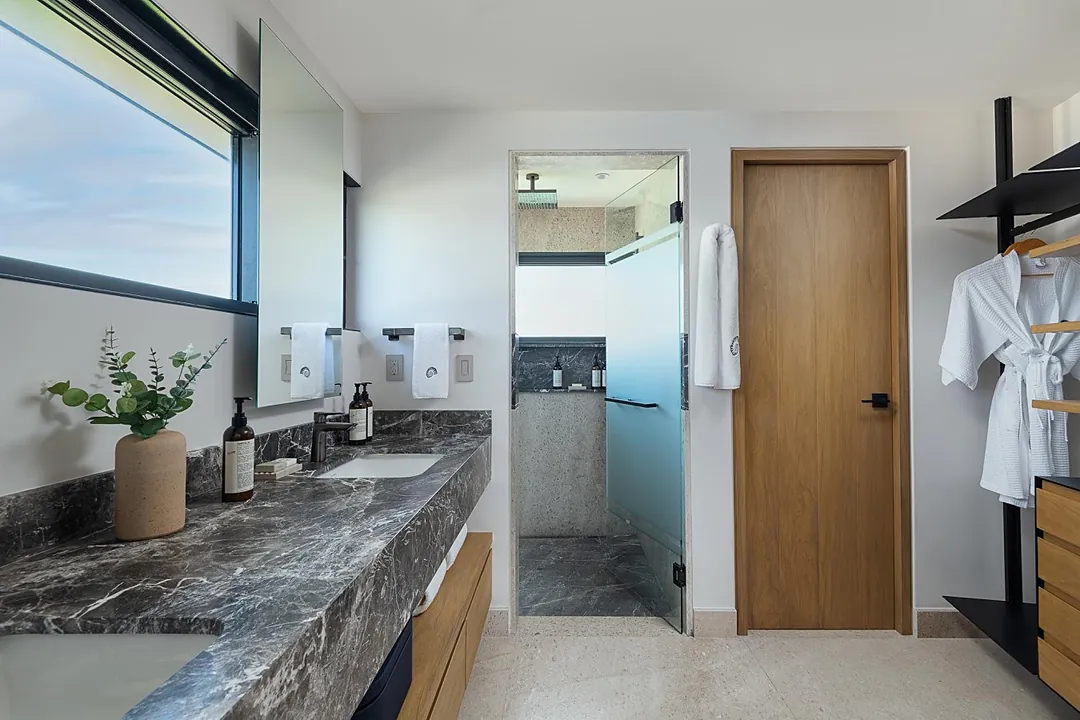 Bathroom 2 · Refresh in your luxurious marble bathroom, complete with a walk-in shower and spa-like finishes. Premium amenities and plush robes await, creating your own private sanctuary to unwind after each day of exploring.