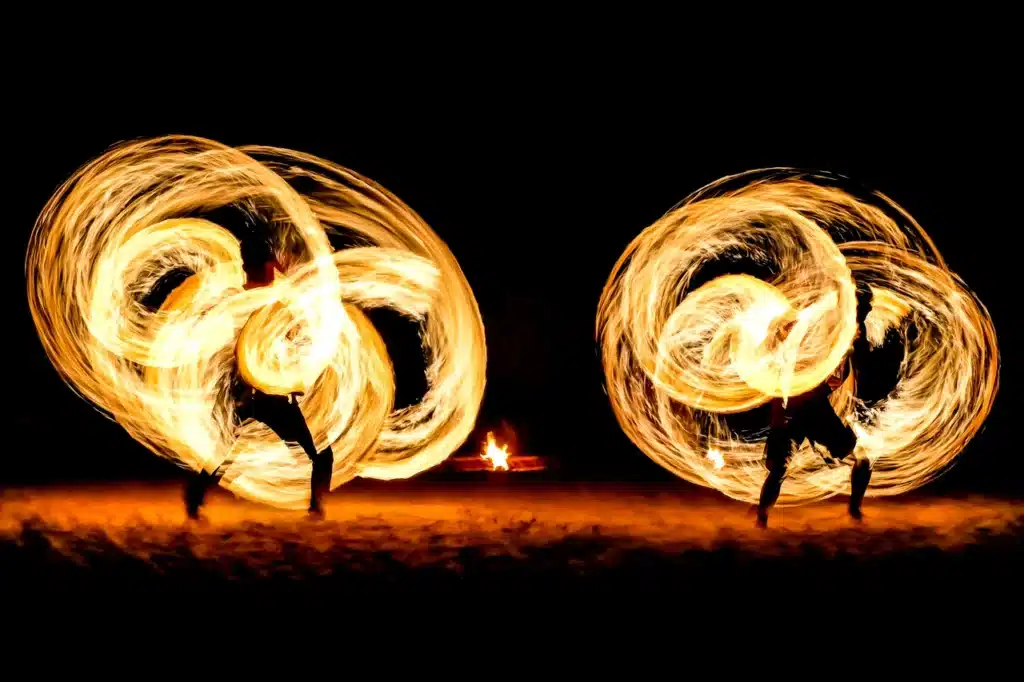 Fire dancers performing at night in Los Cabos