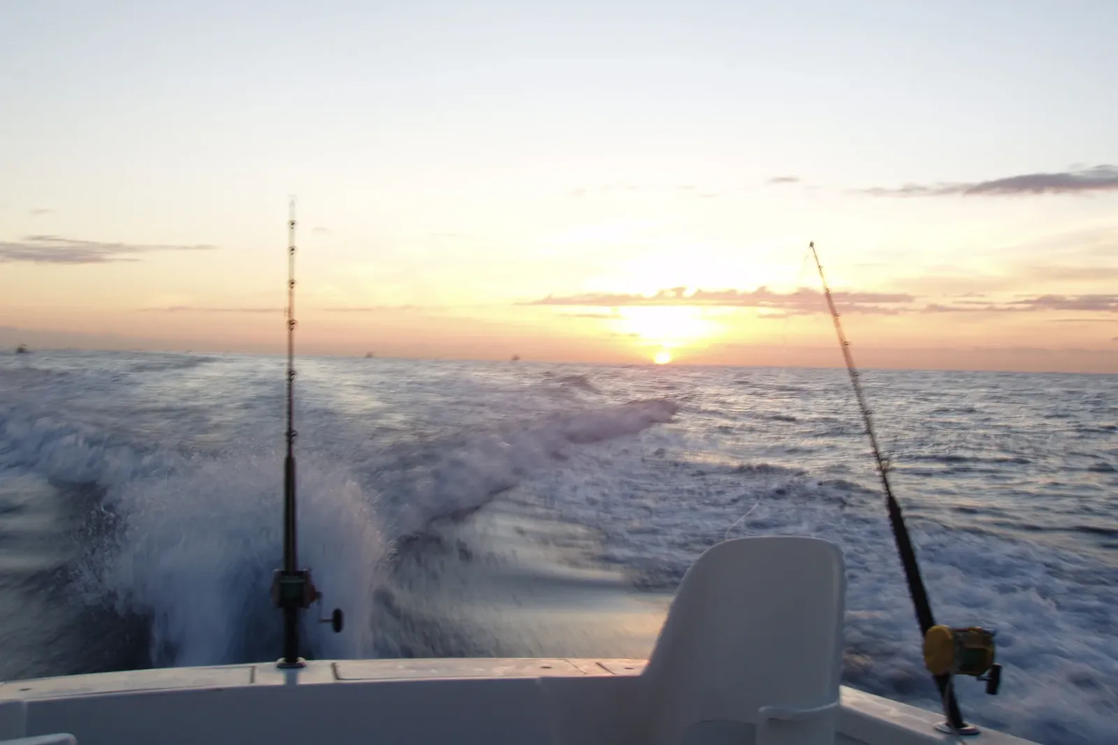 Rods and fighting chair on a sportfishing boat running out of Cabo San Lucas at sunrise