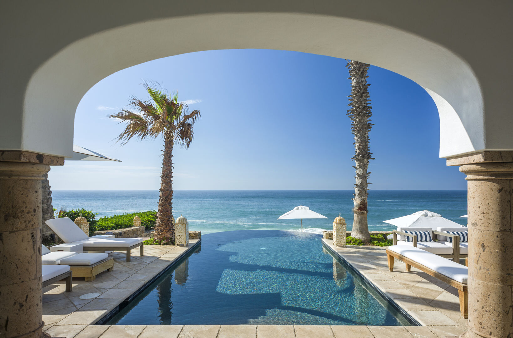 The archway leading to a pool of our Cabo Summer Rentals