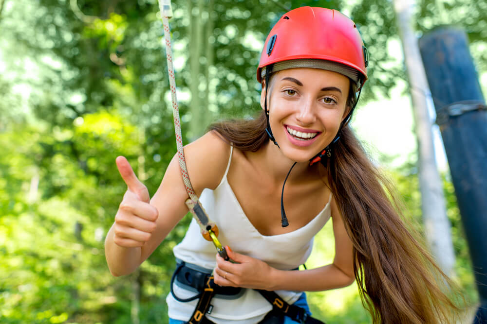 A woman enjoying a zipline in Cabo, Mexico